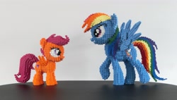 Size: 4225x2407 | Tagged: safe, artist:oilyvalves, rainbow dash (mlp), scootaloo (mlp), equine, fictional species, mammal, pegasus, pony, feral, friendship is magic, hasbro, lego, my little pony, 2020, feathered wings, feathers, female, filly, foal, high res, irl, looking at each other, mare, photo, simple background, smiling, solo, solo female, tail, wings, young