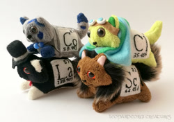 Size: 991x698 | Tagged: safe, artist:leopardcorgi, part of a set, cat, feline, mammal, feral, ambiguous gender, ambiguous only, chlorine, clothes, cobalt, goggles, goggles on head, group, hat, irl, lanthanum, periodic table, photo, photographed artwork, plushie, scandium, tail, towel