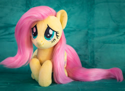 Size: 1984x1446 | Tagged: safe, artist:mofumofumoth, fluttershy (mlp), equine, fictional species, mammal, pegasus, pony, feral, friendship is magic, hasbro, my little pony, 2022, eyelashes, feathered wings, feathers, female, folded wings, fur, hair, irl, mane, mare, photo, pink hair, pink mane, pink tail, plushie, smiling, tail, wings, yellow body, yellow fur